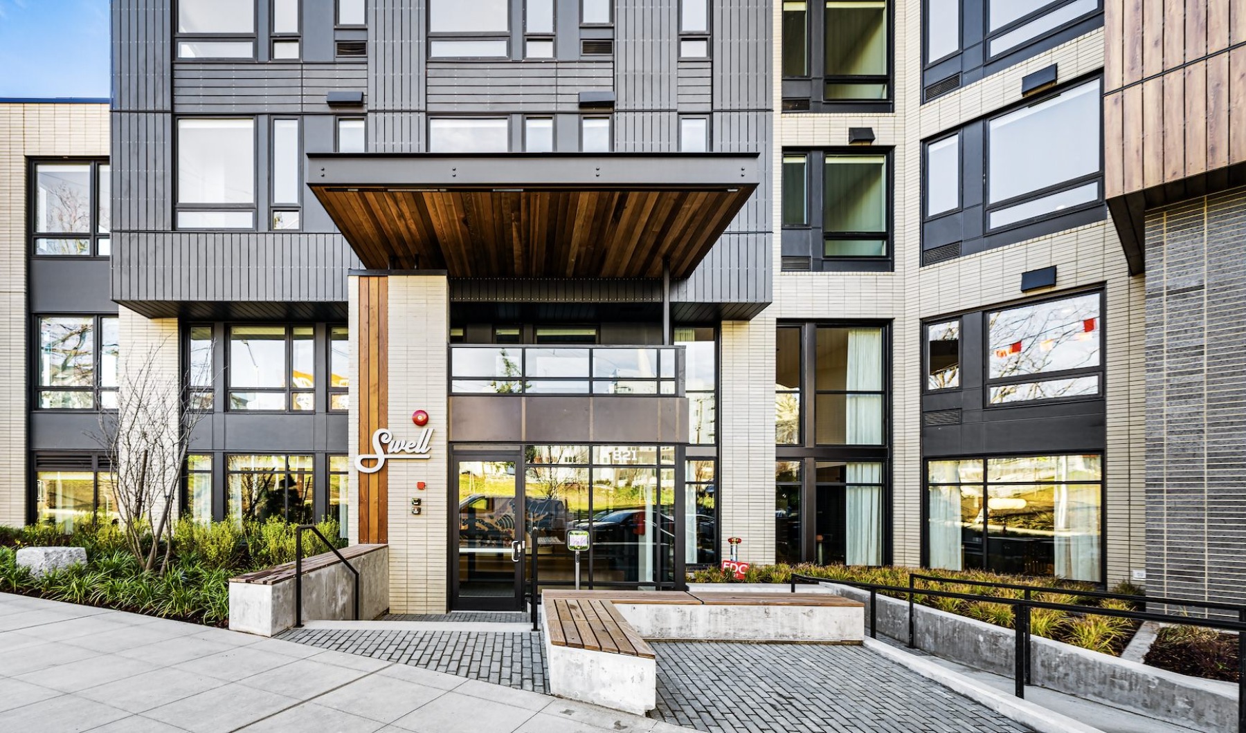 Welcome home entrance to a building with many windows
