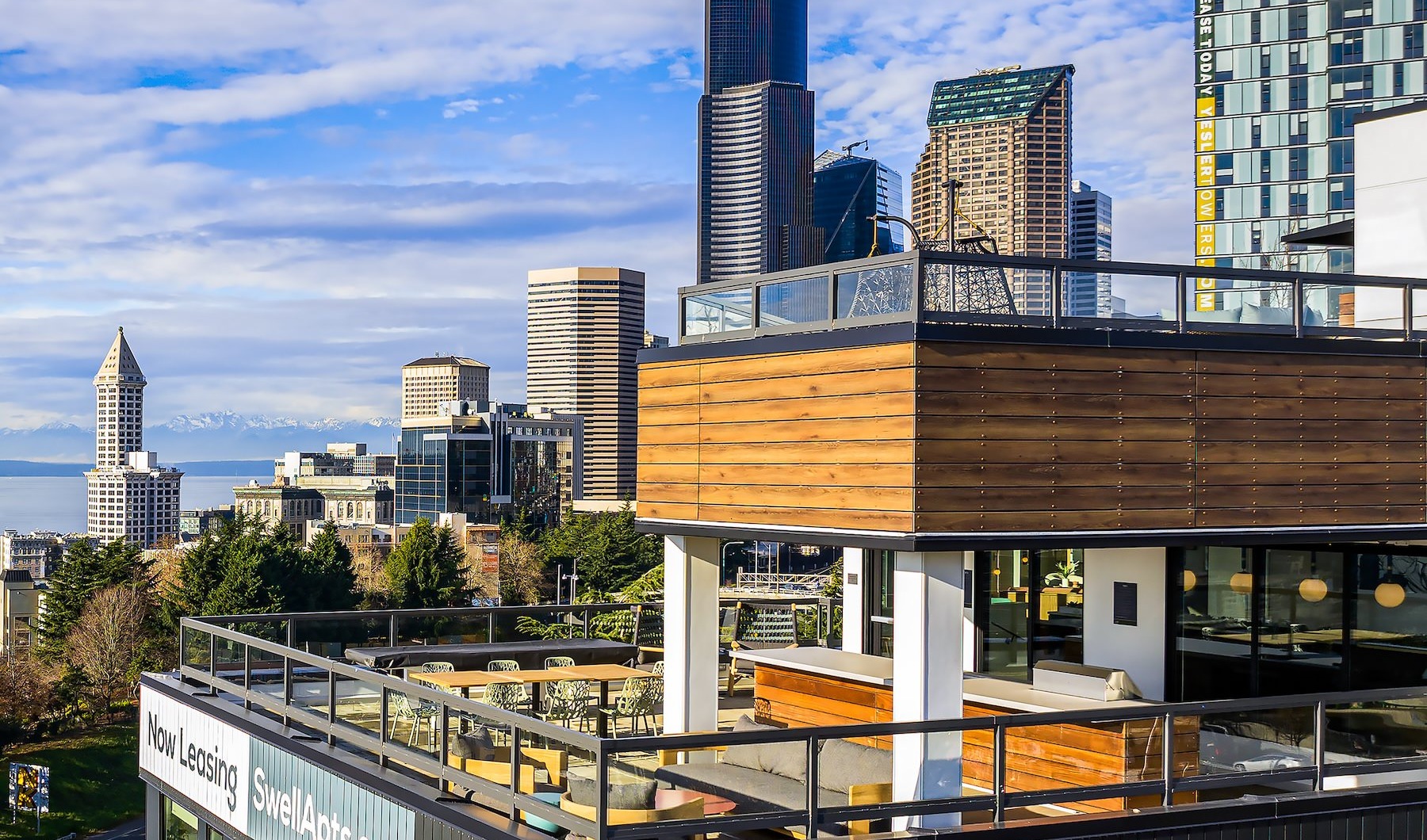 The essence of exceptional living a building with a rooftop terrace and city in the background